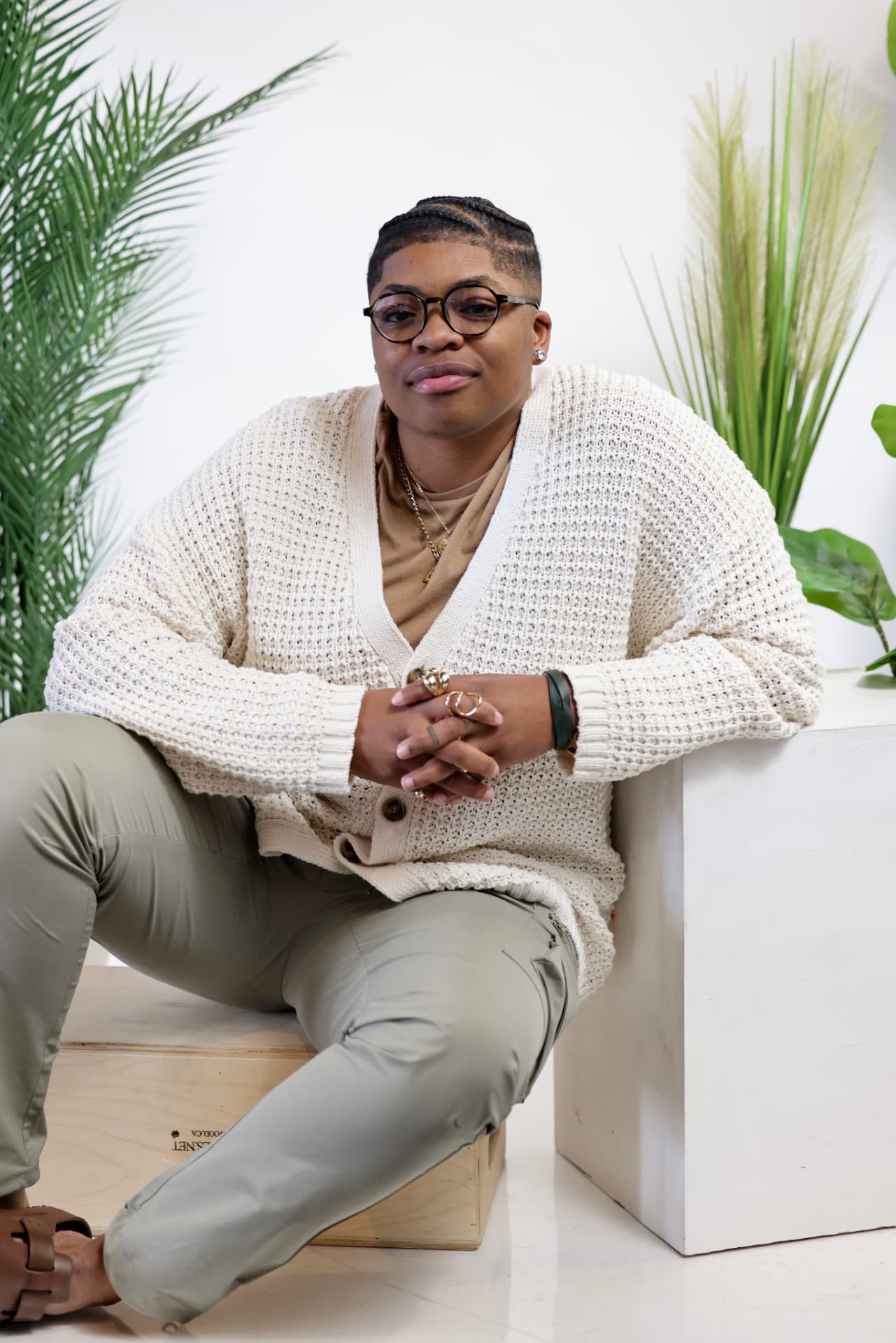 Jannae Gammage seated in a cream cardigan